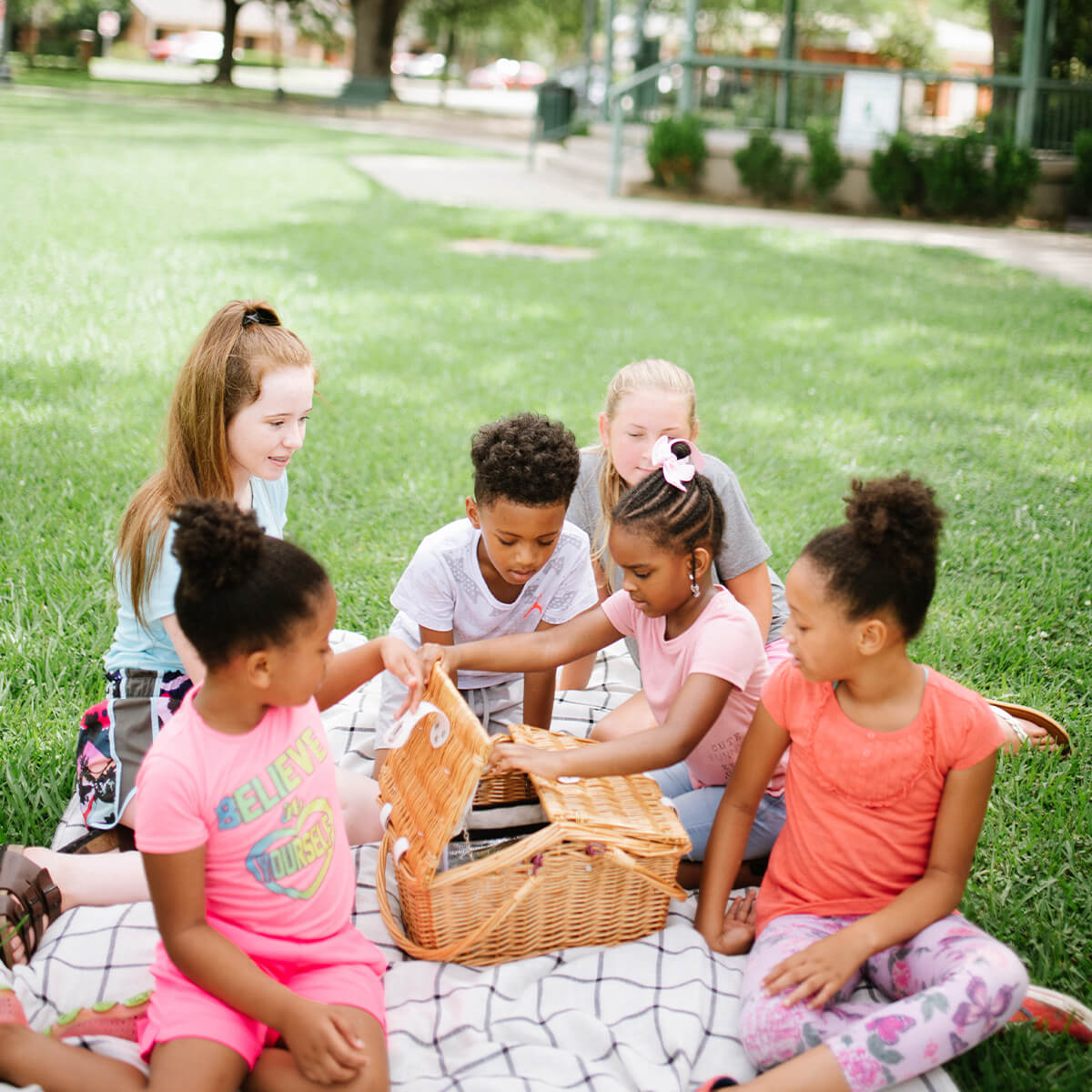 A group of children having a picnic outside at a Hammond, LA park.